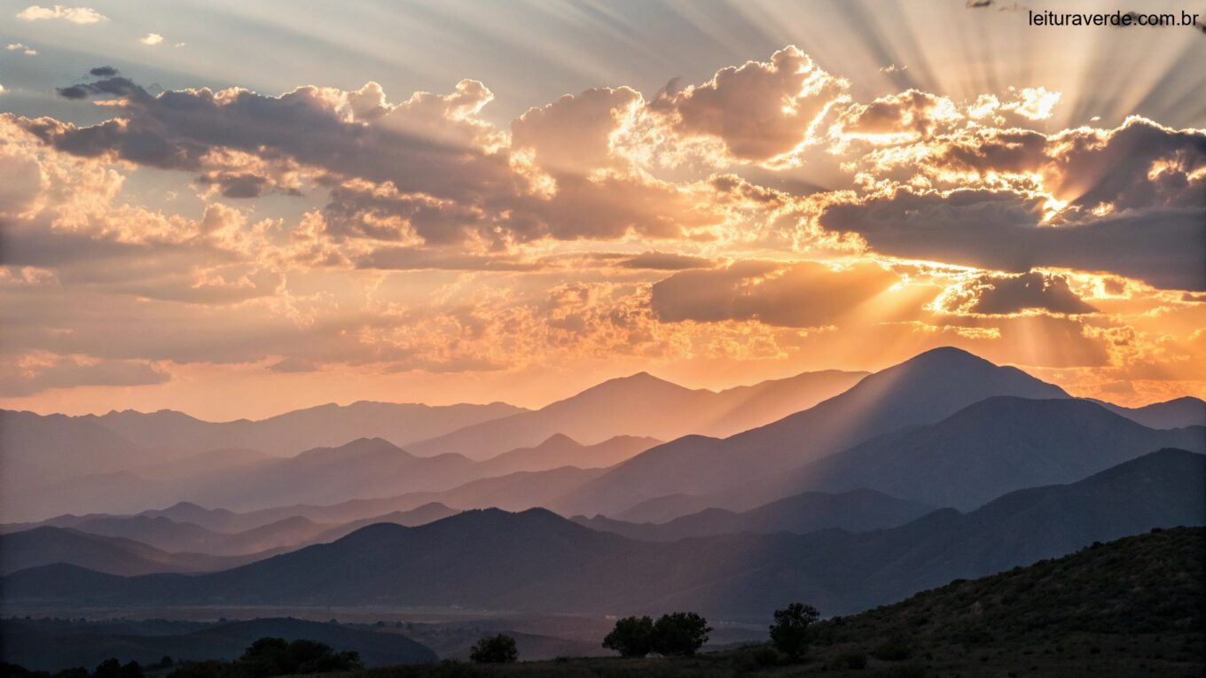 Nascer do sol sereno sobre uma cadeia de montanhas, com raios de luz atravessando as nuvens, simbolizando esperança e novos começos